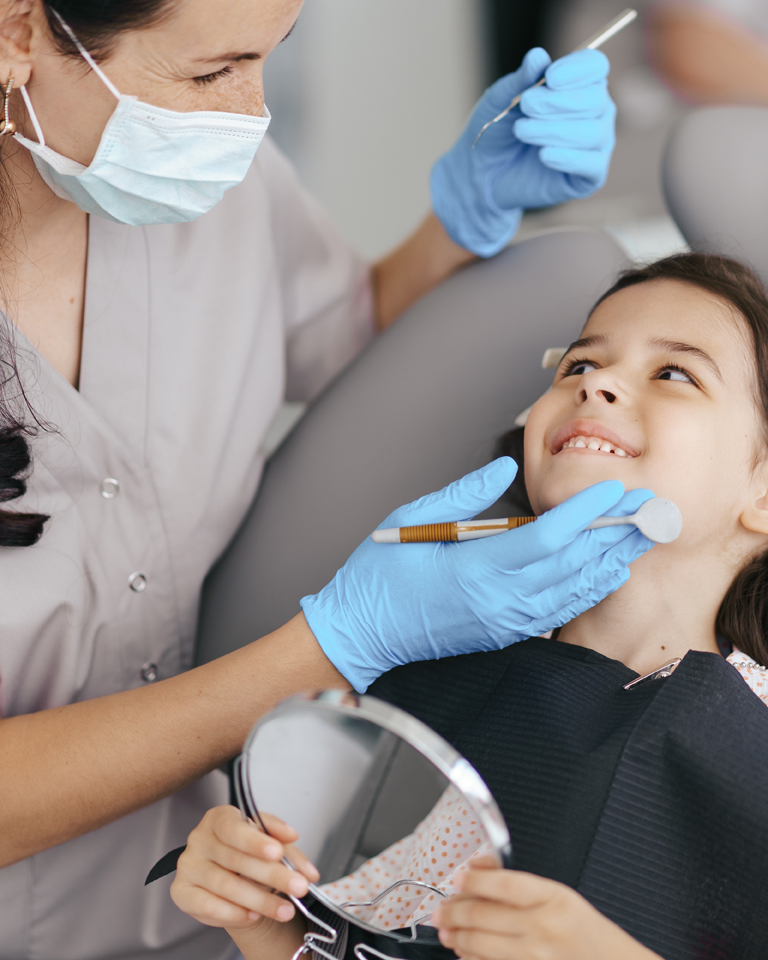 Little beautiful girl at the dentist smiling